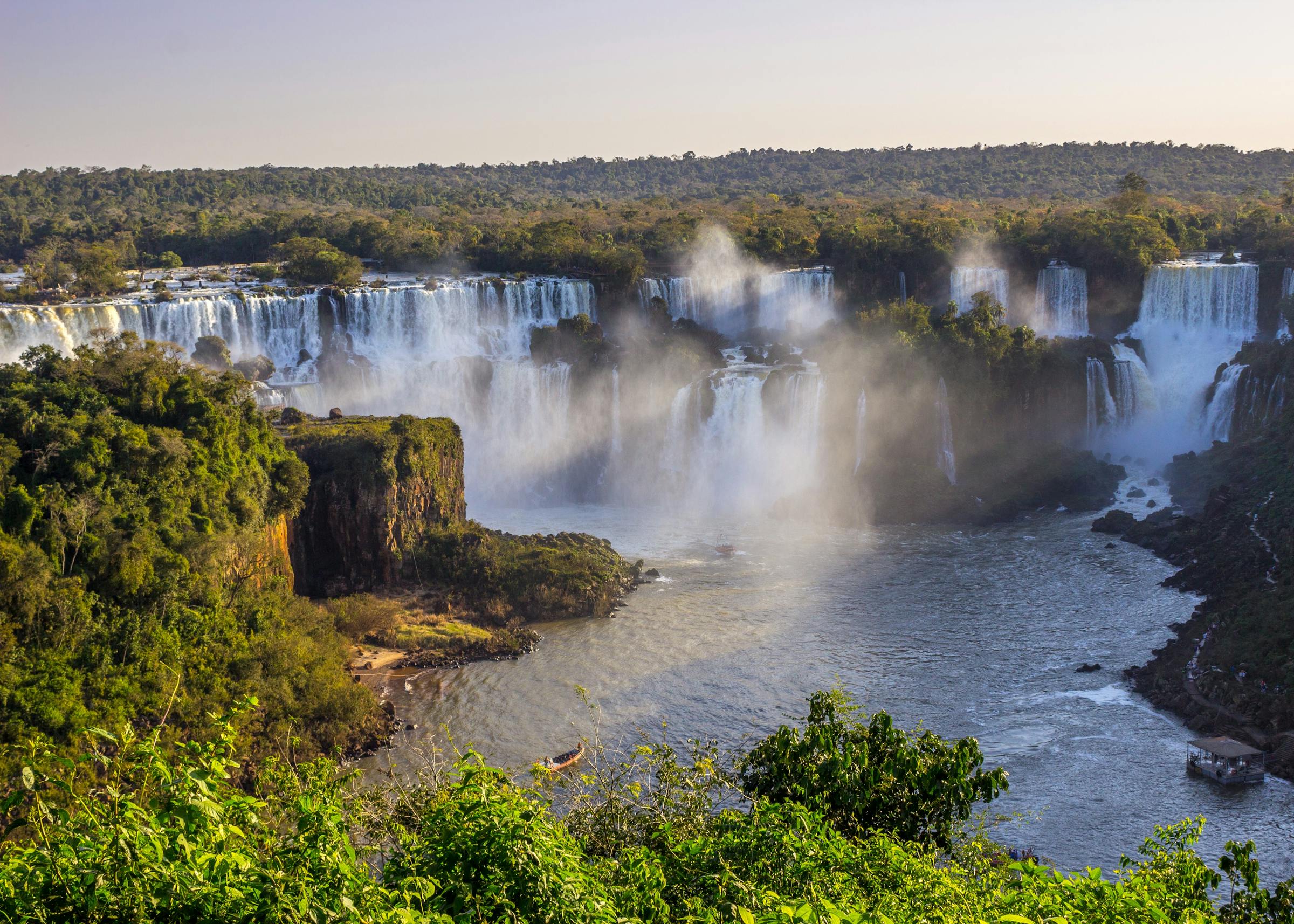 Iguaçu Falls with mist at golden hour