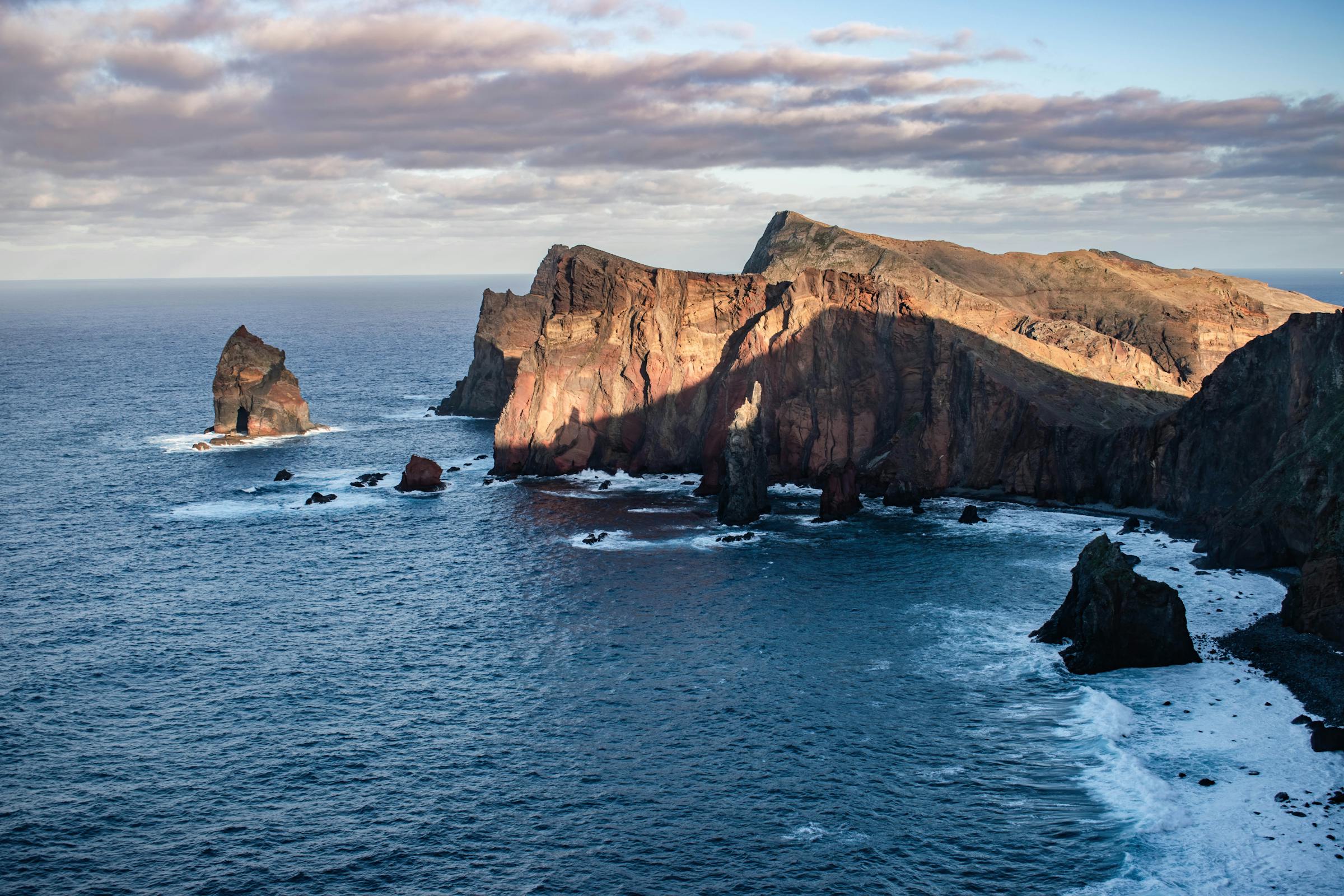 Madeira coastal cliffs with the village of Funchal at dusk