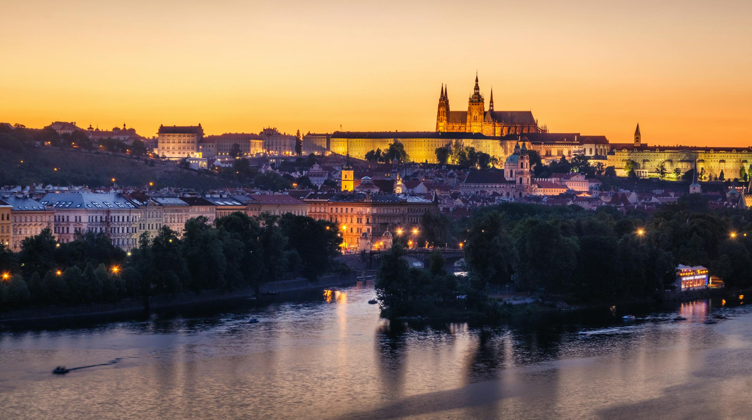 Prague Charles Bridge and Old Town rooftops at dawn