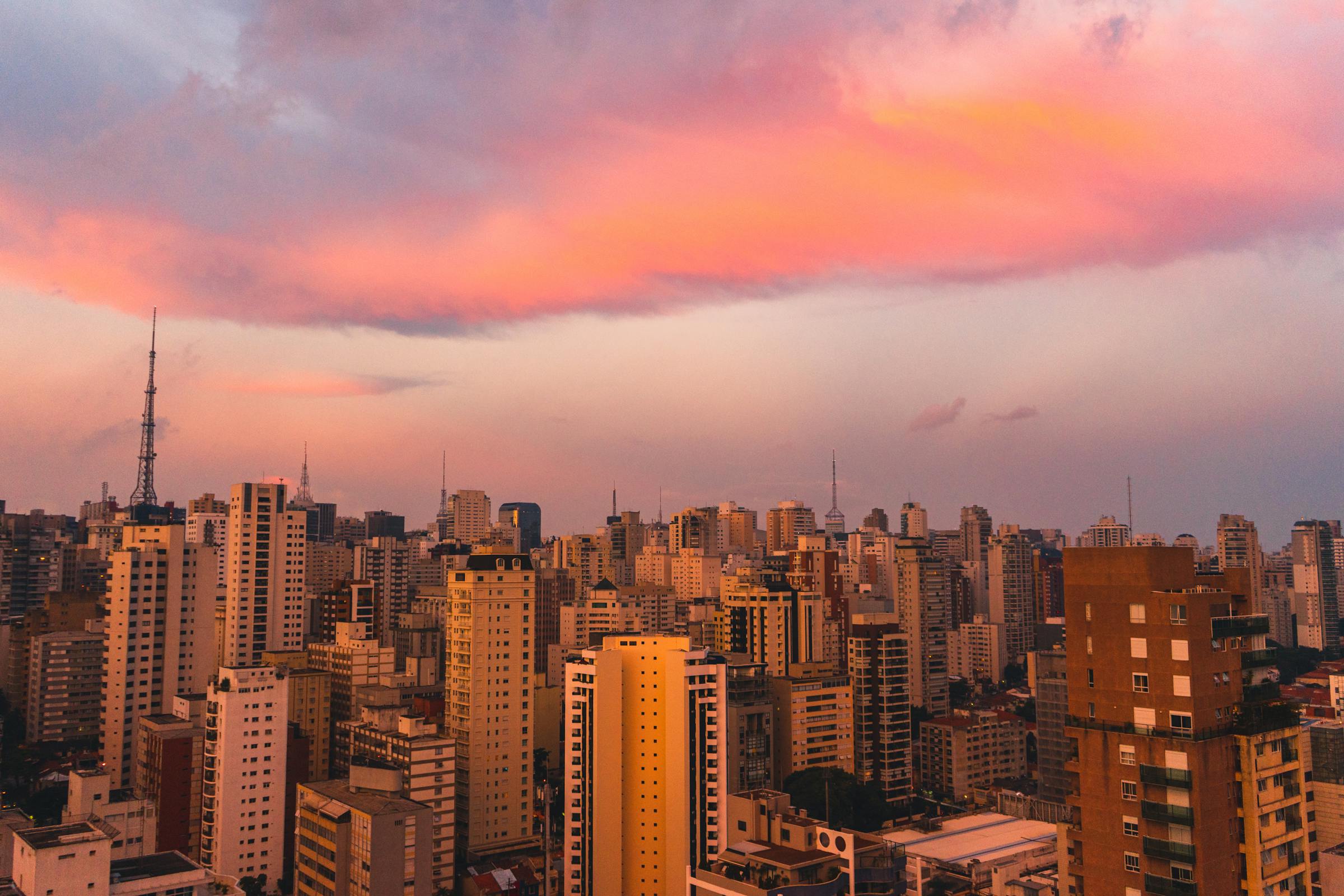 São Paulo skyline at golden hour with city lights coming on